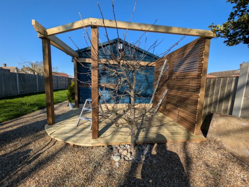 Completed timber pergola and slatted garden screening creating a defined outdoor seating area