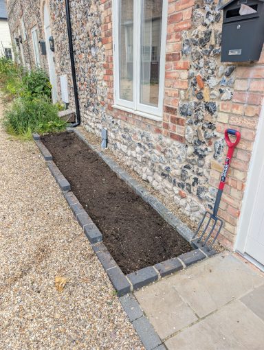 Front bed after being weeded and stripped back to soil