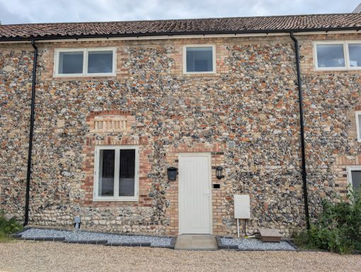 Full front shot of the property after weeding and installation of a low maintenance decorative aggregate