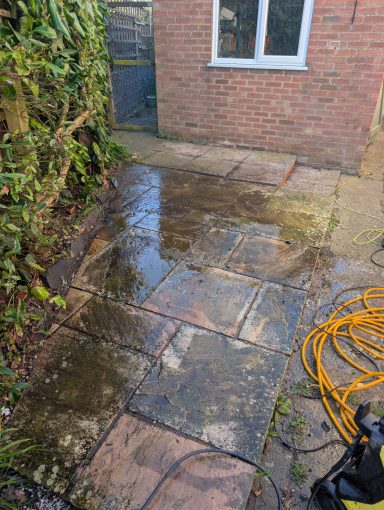 Heavily weathered patio area before pressure washing