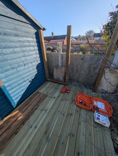 Timber posts and framework during construction of horizontal slatted garden screening