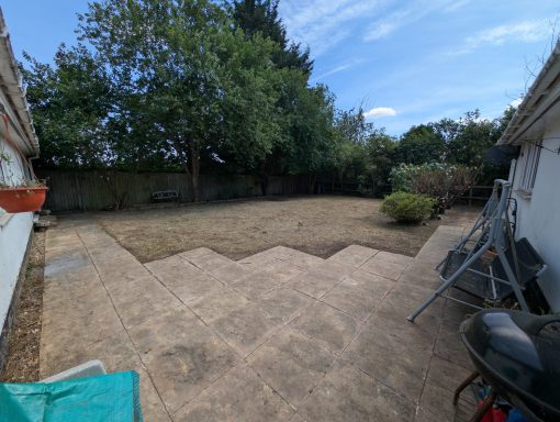 Newly exposed patio and cleared garden view from back door